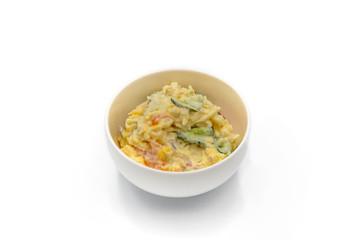 Japanese Potato Salad With Cucumbers, Carrots, and Onion in a bowl isolated on the white 