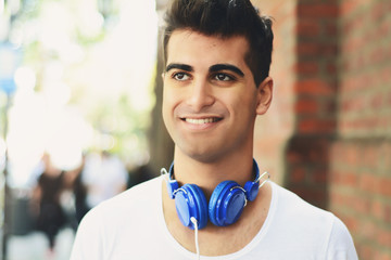 young man listening something. Outdoors.