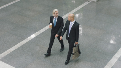 corporate executives walking across lobby of office building