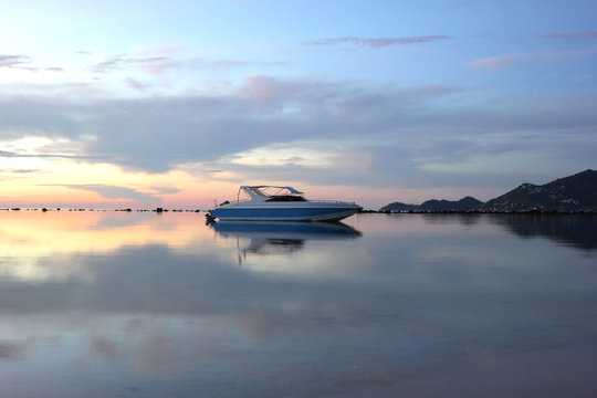 Fototapeta speed boat in the sea with beautiful sunrise