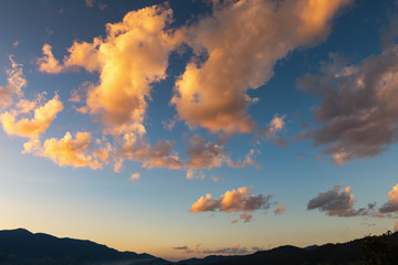 Natural Landscape Scenery View of Clouds and Sky on Evening Sunset, Cloudscape With Mountain Range Scenic at Twilight. Beautiful Nature Scene of Dramatic Sky on Golden Sunlight, Park/Outdoors