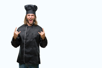 Young handsome cook man with long hair over isolated background shouting with crazy expression doing rock symbol with hands up. Music star. Heavy concept.