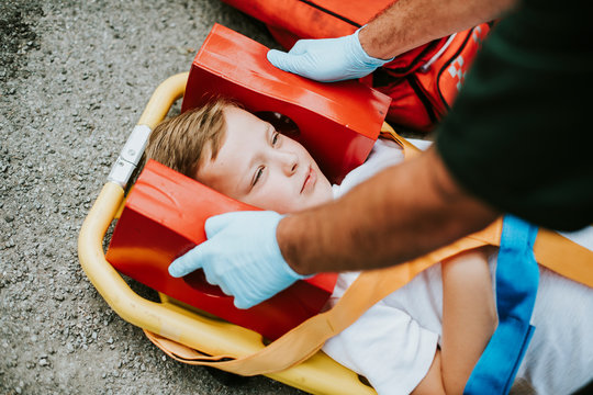 Young injured boy lying on an ambulance stretcher