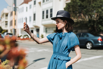 Woman taking a selfie in a city