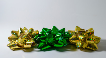 Green and gold bows isolated on white background side view
