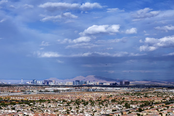 Aerial view of residential neighborhood in notheast Las Vegas and Las Vegas Strip on mountain background. © DMITRY TILT