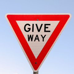 Give Way! Sign against a blue sky. Australian signs found along the road on road trips - inspiration for adventure, travel memories and brochures of signs in Australia for tourists