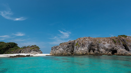 Fototapeta na wymiar scenery of rocky island with clear blue sea and blue sky