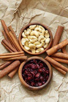 Bowls Of Organic Cranberries And Cashews With Cinnamon Sticks.