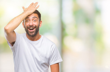 Adult hispanic man over isolated background surprised with hand on head for mistake, remember error. Forgot, bad memory concept. - obrazy, fototapety, plakaty