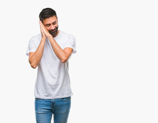 Adult hispanic man over isolated background sleeping tired dreaming and posing with hands together while smiling with closed eyes.