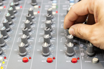 Close up Hand of Man control Microphone on Mixing Console of a big HiFi system, The audio equipment...