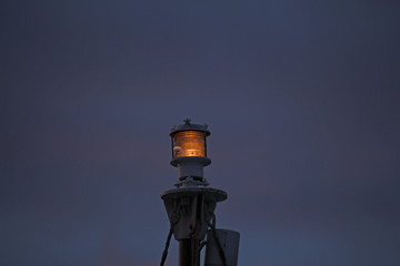 lantern burning in the twilight against the dark sky