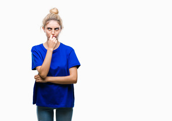 Young beautiful blonde and blue eyes woman wearing blue t-shirt over isolated background looking stressed and nervous with hands on mouth biting nails. Anxiety problem.