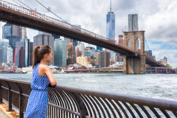 Fototapeta premium Nowy Jork miasta NYC lata podróży turystyczna kobieta cieszy się widok Manhattan linia horyzontu od Brooklyn parka żyje szczęśliwego stylu życia odprowadzenie podczas usa wakacje. Żeński Azjatycki turysta w jej 20s.