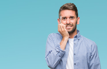 Young handsome man wearing white t-shirt over isolated background looking stressed and nervous with...