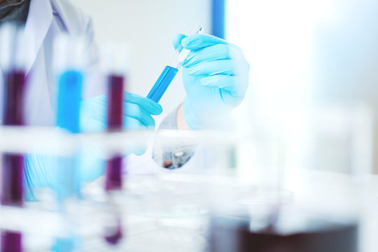 Scientist with equipment holding tools during scientific experiment science concept