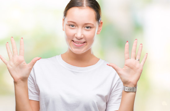 Young beautiful caucasian woman over isolated background showing and pointing up with fingers number ten while smiling confident and happy.
