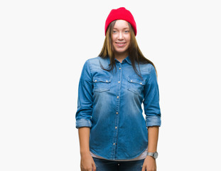 Young caucasian beautiful woman wearing wool cap over isolated background with a happy and cool smile on face. Lucky person.