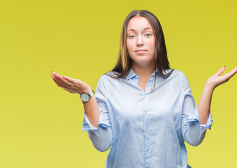 Young caucasian beautiful woman over isolated background clueless and confused expression with arms...