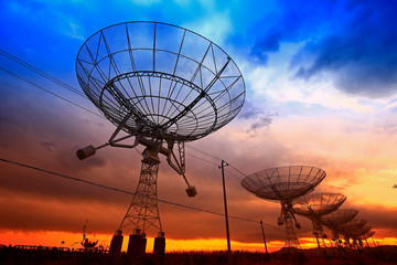 The silhouette of a radio telescope observatory