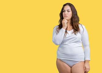 Beautiful plus size young overwight woman wearing white underwear over isolated background Relaxed with serious expression on face. Simple and natural with crossed arms