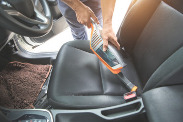 man hands using vacuum cleaner interior car