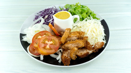 Fried chicken Salad in Plate on white background, Healthy salad diet food concept, Top view, with copy space for your text..