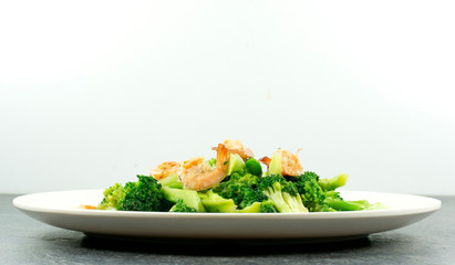 Healthy eating, food and weigh loss concept - close up broccoli with shrimp on stone background..