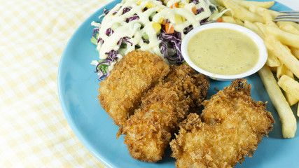 Fried fish steak in a dish on a table. Food background concept. Top view with copy space for your text..