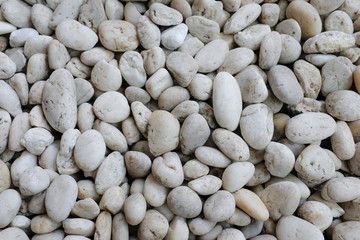 White natural river rocks and pebbles background texture