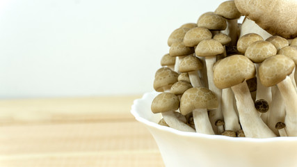 Mushrooms in white cup. vegan food, vitamin snack on wooden background ,Top view, Copy space..