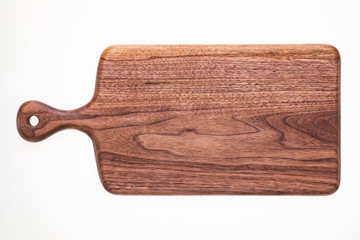 Handmade walnut chopping board, natural texture element background.