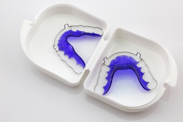 Blue Acrylic dental retainer isolated in white box on white - obrazy, fototapety, plakaty