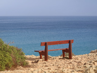 single bench in the park Cavo Greco in Ayia Napa, cyprus overlooking the mediterranean Sea