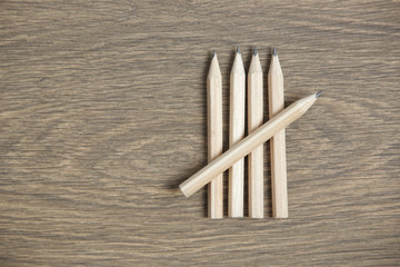 Groups of five wooden pencils arranged as tally or hash marks, a form of numeral used for counting mostly ongoing results, such as the score in a game or sport - obrazy, fototapety, plakaty