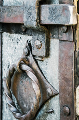 old and rusty latch and handle on metal door. old castle, house, basement or room door