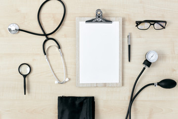 Workplace doctor clipboard stethoscope top view