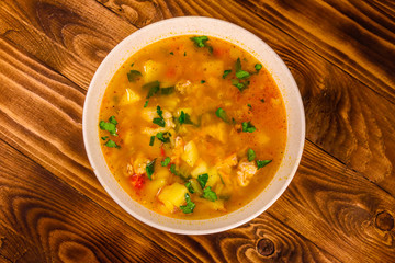 Georgian traditional food soup kharcho on wooden table. Top view