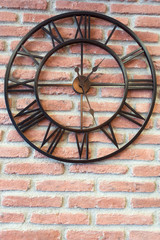 Fototapeta na wymiar Metal Clock on Red Brick Wall Background