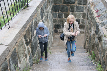 Mother and her daughter teenager climb the stairs.