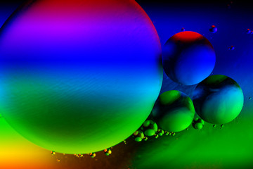 Abstract colorful background with oil drops and reflections on water surface. Cosmic abstract image