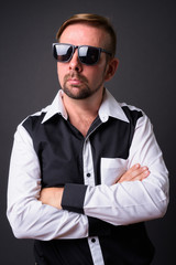 Obraz premium Blond bearded businessman with goatee against gray background