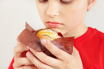 Little cut boy with a apple cake on a white background close up