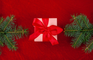 Christmas gifts with red ribbon on red background with decorations. Christmas background with copy space.