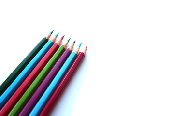 colored pencils in the corner of a sheet