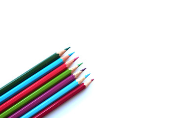 colored pencils in the corner of a sheet top view