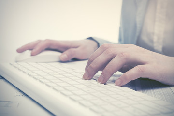 Business woman using computer mouse and keyboard