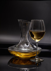 A glass full of wine and wine decanters