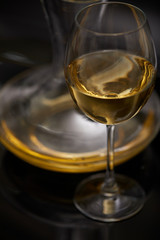 A glass full of wine and wine decanters